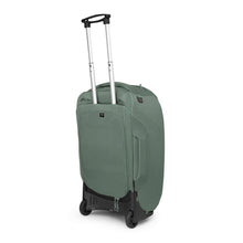 Load image into Gallery viewer, Angled back panel view of the Koseret green travel pack. The telescopic handle is extended.