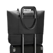 Load image into Gallery viewer, Briggs & Riley Rhapsody Expandable Tote - Shown in Black
Image of Back Panel Attachment Feature allowing for tote to ride along the telescoping handles of most carry-on trolley bags.
Dimensions: 13.5 x 19.5 x 7.5 in / 34.4 x 49.5 x 19.1 cm