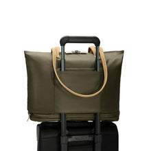 Load image into Gallery viewer, Briggs & Riley Rhapsody Expandable Tote - Shown in Olive
Image of Back Panel Attachment Feature allowing for tote to ride along the telescoping handles of most carry-on trolley bags.
Dimensions: 13.5 x 19.5 x 7.5 in / 34.4 x 49.5 x 19.1 cm