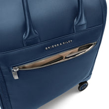 Load image into Gallery viewer, Briggs & Riley Rhapsody Wheeled Cabin Bag - Shown in Navy
Image of Front Panel zippered pocket with quick access to airline ticket, passport, etc.
Dimensions: 16 x 14 x 8.5 in / 40.6 x 35.6 x 21.6 cm (includes wheels and handles)