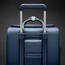 Load image into Gallery viewer, Briggs & Riley Rhapsody Wheeled Cabin Bag - Shown in Navy
Image of Attachment Feature which allows this Wheeled Cabin Bag to ride along the telescoping handle of your carry-on wheeled trolley bag
Dimensions: 16 x 14 x 8.5 in / 40.6 x 35.6 x 21.6 cm (includes wheels and handle)