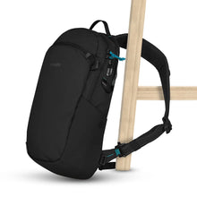 Load image into Gallery viewer, The black sling bag attached to a chair leg.