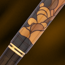 Load image into Gallery viewer, Close-up of the fountain pen barrel with decorative cloud pattern and gold accent on a dark background.