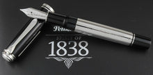 Load image into Gallery viewer, The fountain pen leaning on the cap.