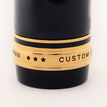 Load image into Gallery viewer, Close up to the golden cap with three stars engraved.