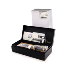Load image into Gallery viewer, Angled front view of the fountain pen arranged with the documents and ink cartridge inside the presentation box. The white dust sleeve is standing behind.