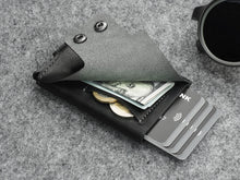 Load image into Gallery viewer, Interior view of the wallet's back. Six credit cards, two coins and a bill are tucked inside.