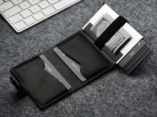 Load image into Gallery viewer, Interior view of the black wallet with credit cards and cash tucked in the compartments.