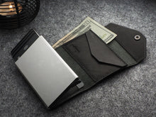 Load image into Gallery viewer, Angled interior view of the wallet with cards and a bill tucked inside.