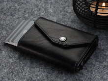 Load image into Gallery viewer, Angled view of the black wallet with six credit cards peeking from the side.