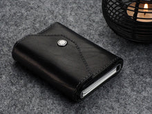 Load image into Gallery viewer, Angled view of the wallet with six cards tucked in the aluminum case.