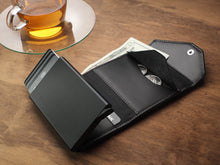 Load image into Gallery viewer, Interior view of the black wallet with cards, cash and coins arranged inside.
