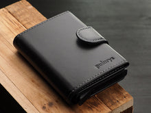 Load image into Gallery viewer, Angled front view of the black wallet with pularys embossing.
