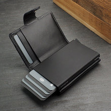Load image into Gallery viewer, Interior view of the black leather wallet with six credit cards peeking from the lever case.