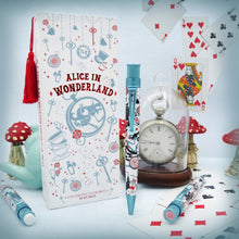 Load image into Gallery viewer, Arrangement of the Alice in Wonderland Pen with the packaging, pencil, and a series of playing cards a hand watch, and mushroom figures (not included)