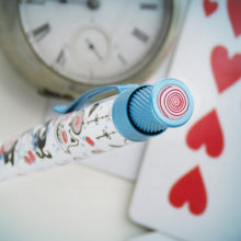 Load image into Gallery viewer, Top view of the Alice in Wonderland pen's disk. It is pink with a red spiral