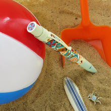 Load image into Gallery viewer, The Retro 51 Beachy Side-Up Pen on a beach themed set featuring a pail, a crab figure, a surf board, and a beach ball.