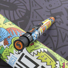 Load image into Gallery viewer, Angled top disk view of the pen, it features the icon of a black brontosaurus