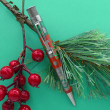 Load image into Gallery viewer, The Retro 51 Limited Edition Lionel Trains Christmas Light Express sits atop a Rowan tree branch with a green background.