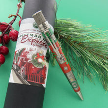Load image into Gallery viewer, The Retro 51 Limited Edition Lionel Trains Christmas Light Express sits atop the presentation tube. There is a green background.