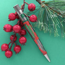 Load image into Gallery viewer, The Retro 51 Limited Edition Lionel Trains Christmas Light Express sits atop a Rowan tree branch, the pen is sideways and it reads Season Greetings in a festive green lettering.