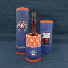 Load image into Gallery viewer, Comemmorative tube of pen on a blue background.