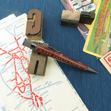 Load image into Gallery viewer, Pen with 'Pennsylvania' on it on a map and blue textured surface.