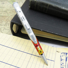 Load image into Gallery viewer, Front view of the rollerball pen leaning on some notepads and folders.