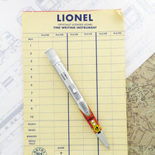 Load image into Gallery viewer, Front view of the rollerball pen on a pad with yellow paper.