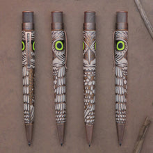 Load image into Gallery viewer, Front, back, and side views of The Retro 51 Owl Rescue Rollerball Pen on a brown textured background. The pen has a acid eetched design of the owl body around the barrel. The eyes are a bright lime green and glow in the dark.