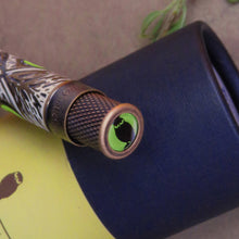 Load image into Gallery viewer, Top disk close up on the pen. It has a lime green and black icon of an owl.