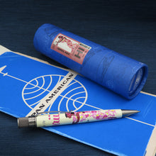 Load image into Gallery viewer, Side view of the pen arranged with the gift tube and a Pan American World Airways ticket