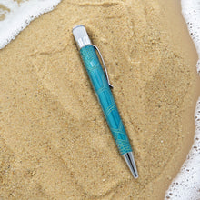 Load image into Gallery viewer, Side view of the pen laid on sand and sea foam.