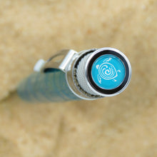 Load image into Gallery viewer, Top view of the The Retro 51 Sea Turtle Rescue Pen. The disk has a light background with a white icon of a turtle.