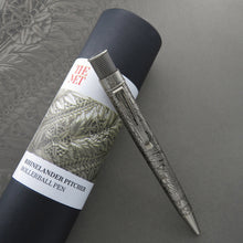 Load image into Gallery viewer, The rollerball pen leaning on the gift tube.