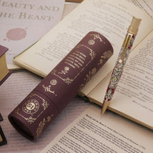 Load image into Gallery viewer, Decorative pen with satin gold accents on an open book