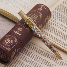 Load image into Gallery viewer, Pen with Stained-glass design on an open book.