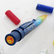 Load image into Gallery viewer, Top disk view of the pen, featuring orange, red and yellow shapes. The background is white with a red and blue yellow pastel.