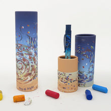 Load image into Gallery viewer, The pen arranged with two matching gift tubes on a white background with pieces of oil pastel.