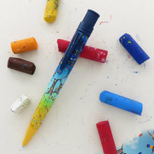 Load image into Gallery viewer, Front view of the pen with pieces of oil pastel on a white background.