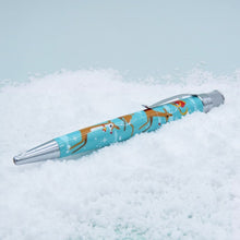 Load image into Gallery viewer, Angled side view of the Christmas themed pen on a snowy background.