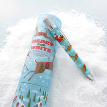 Load image into Gallery viewer, The Christmas themed pen leaning on its matching packing gift tube on a snowy background.