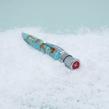 Load image into Gallery viewer, Angled top panel view of the pen, showing a top red disk with a four point star.