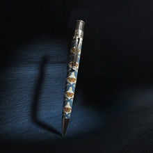 Load image into Gallery viewer, Front view of the pen on a textured dark blue background.