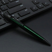 Load image into Gallery viewer, Green pen leaning on a black keyboard.