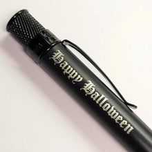Load image into Gallery viewer, A matte black pen with engraving in black letter font : Happy Halloween.