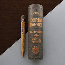 Load image into Gallery viewer, Front view of the The Retro 51 Tornado Woodworks Bourbon barrel Pen with the gift tube to the side. Set on a white and brown wooden textured background.