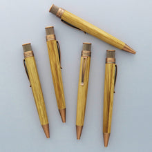 Load image into Gallery viewer, Front, back and side views of The Retro 51 Tornado Woodworks Bourbon barrel Pen on a light gray background.