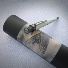 Load image into Gallery viewer, The Retro 51 A-10 Warthog Rollerball Pen leaning on the gift tube. The top has a rotary auto-cannon on the disk.