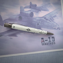 Load image into Gallery viewer, Side view of the Retro 51 A-10 Warthog Rollerball Pen on top of a plane's graphic.